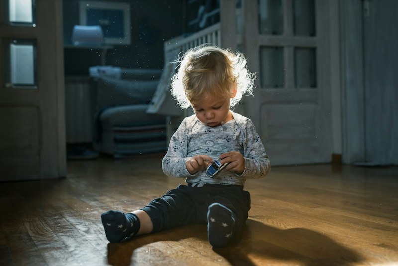 A girl sitting on the floor, thinking